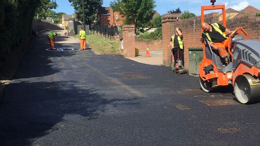 The tarmaccing of a road