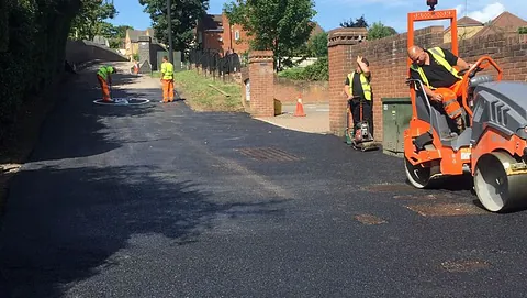 The tarmaccing of a road